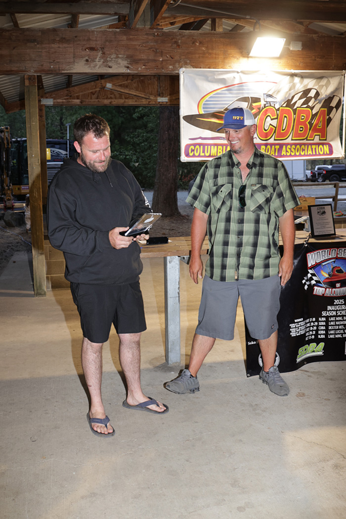 Commodore Cole Billings awarding a participation trophy to James Collett, who used that to issue a challenge to the TAH winner Jeff Berr. The “Stealth 2.0” team had no comment. 